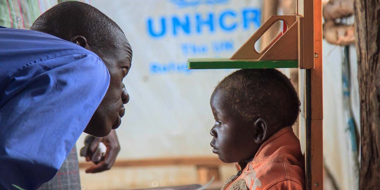 A-doctor-checks-the-height-of-a-refugee-child-in-one-of-the-temporary-UNHCR-medical-centres-in-bidibidi-refugee-campYumbeUganda