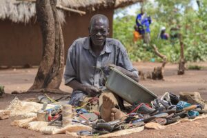 A-refugee-cobler-repairs-shoes-in-bidibidi-refugee-camp-Yumbe-Uganda
