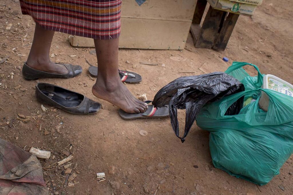 The-switch-Annet-changes-her-shoes-as-she-changes-proffesions-to-street-vending-in-kalerweUganda